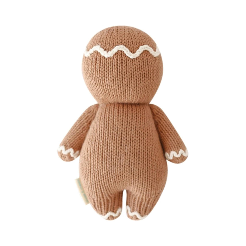 Knitted gingerbread man person, back view, on a white background.