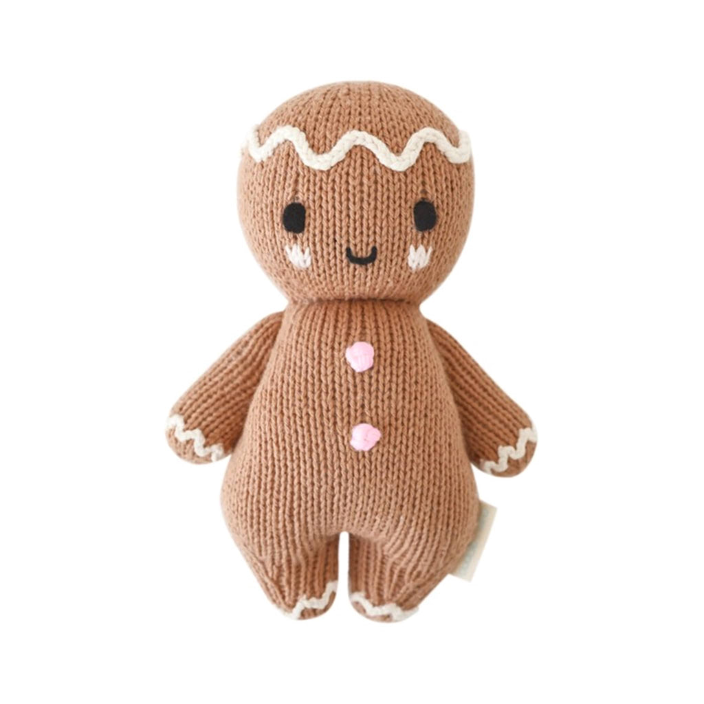 Knitted gingerbread person toy on a white background.