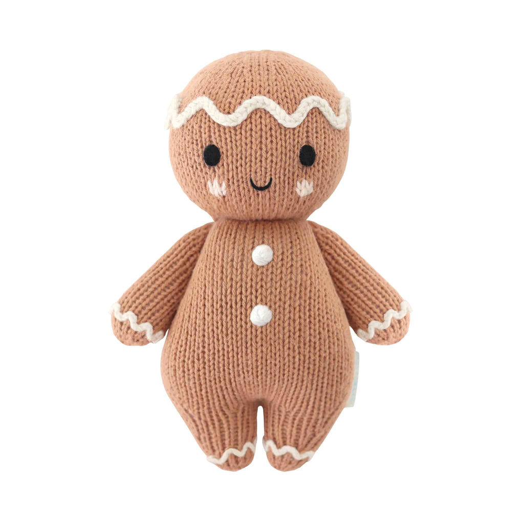 Knitted gingerbread person toy on a white background.