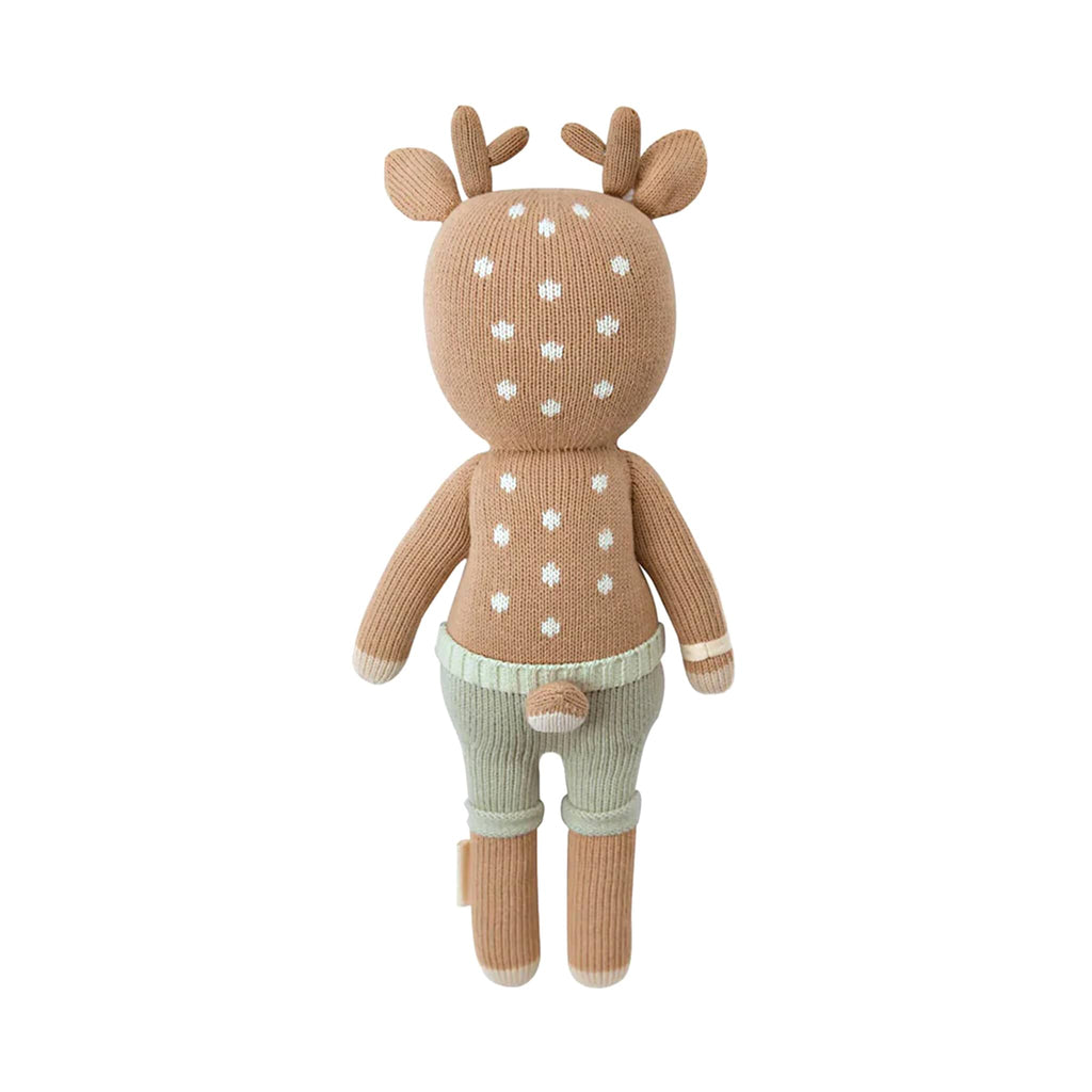 Knitted deer toy with sage green shorts, back view, on a white background.