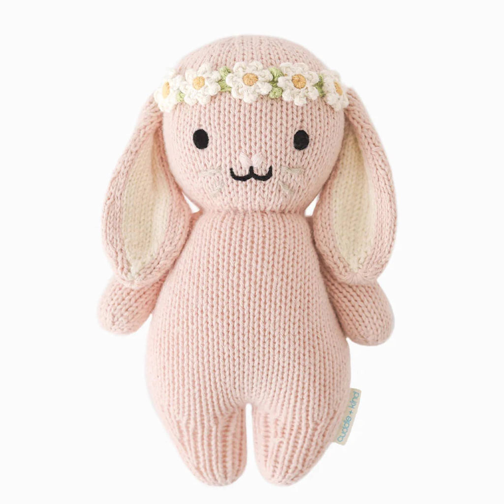 Cuddle and Kind Baby Bunny rose with ivory floral headband, hand knit doll, front view.