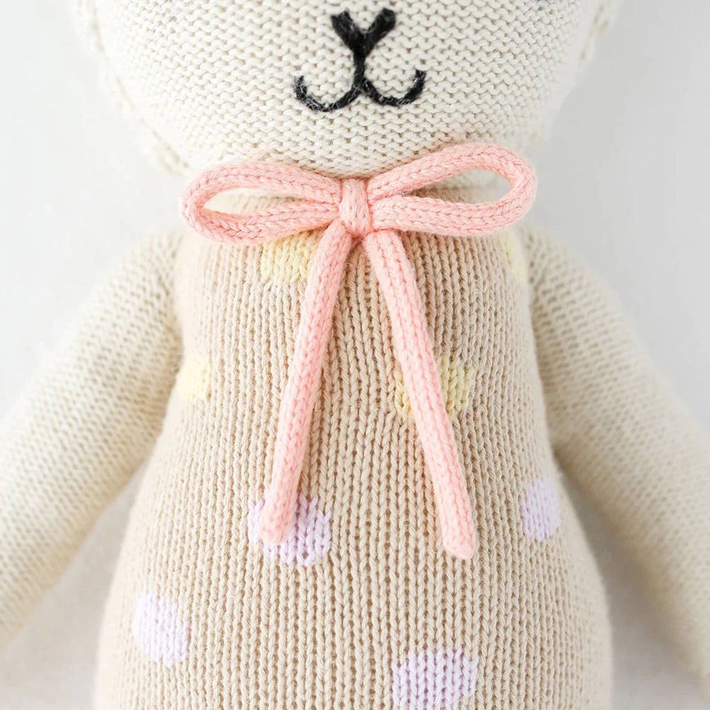 Cuddle and Kind Lucy the Lamb hand knit doll, detail of bow and outfit.