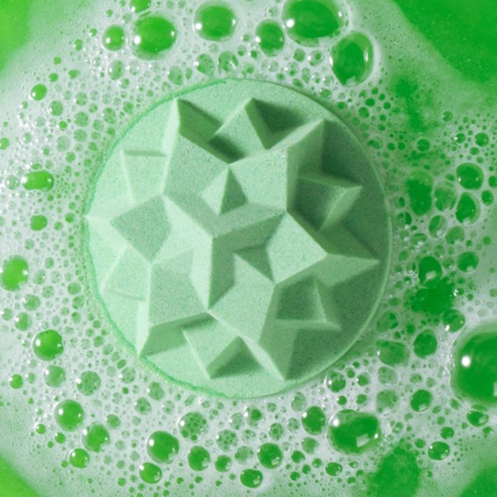 Green star-shaped bath fizzer with bubbles on a green background.