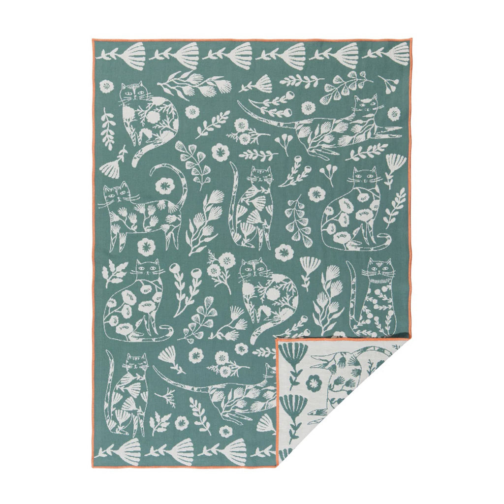 Danica Catbloom double cloth dishtowel, white on green background with corner flipped back to see reverse side.