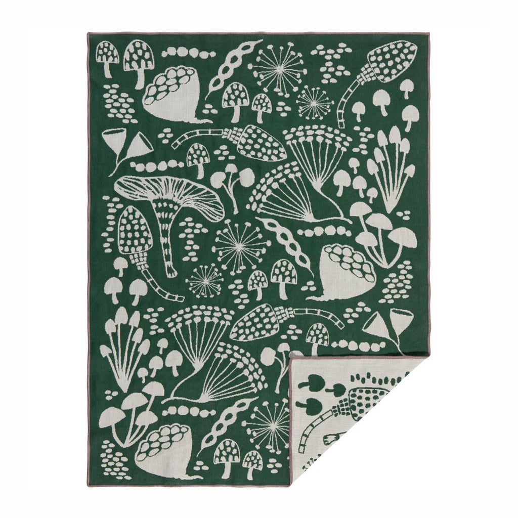Wildgrove Two-sided dish towel with green and white mushroom print, corner folded back.