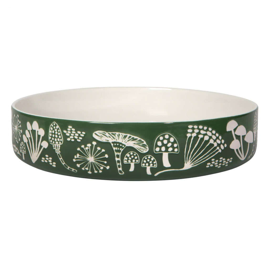 Green serving bowl with white floral and mushroom pattern on a white background.