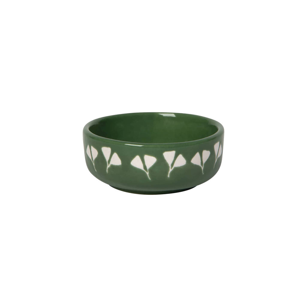 Small green ceramic dish with white floral wax-resist patterns around the outside, on a white background.