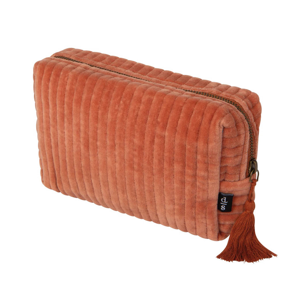 Copper orange color quilted velvet pouch with a tassel, front angle view, on a white background.