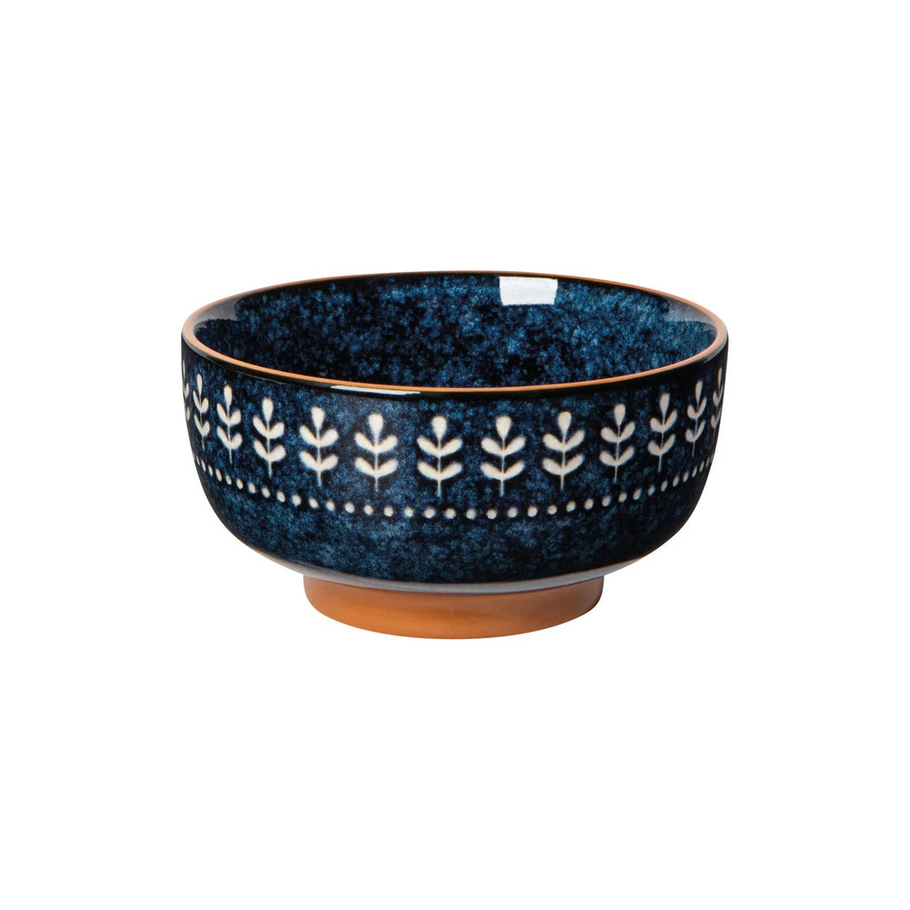 Blue ceramic bowl with white floral pattern on a white background.