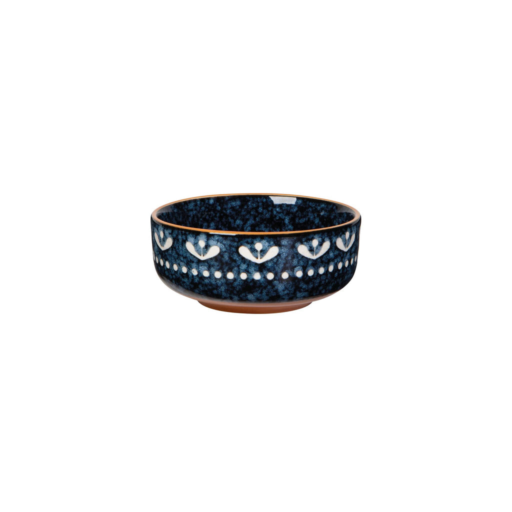Blue ceramic bowl with white floral patterns on a white background.