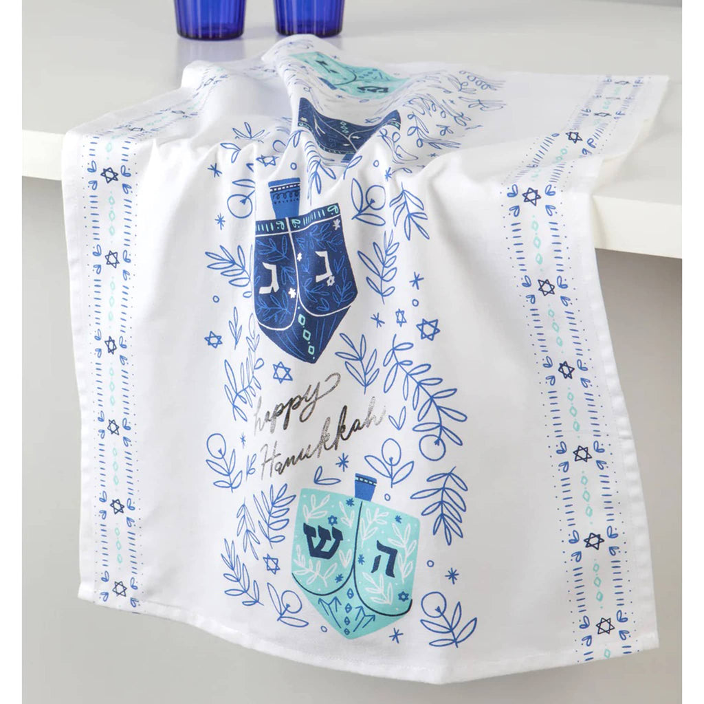 Decorative towel with Hanukkah-themed designs on a white surface.