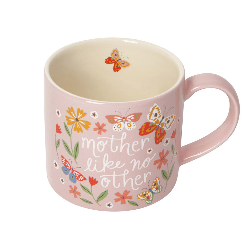Danica pink stoneware mug with "mother like no other" in white lettering surrounded by colorful butterflies and flowers, handle is on the right, slight overhead view showing white interior and a little butterfly illustration.