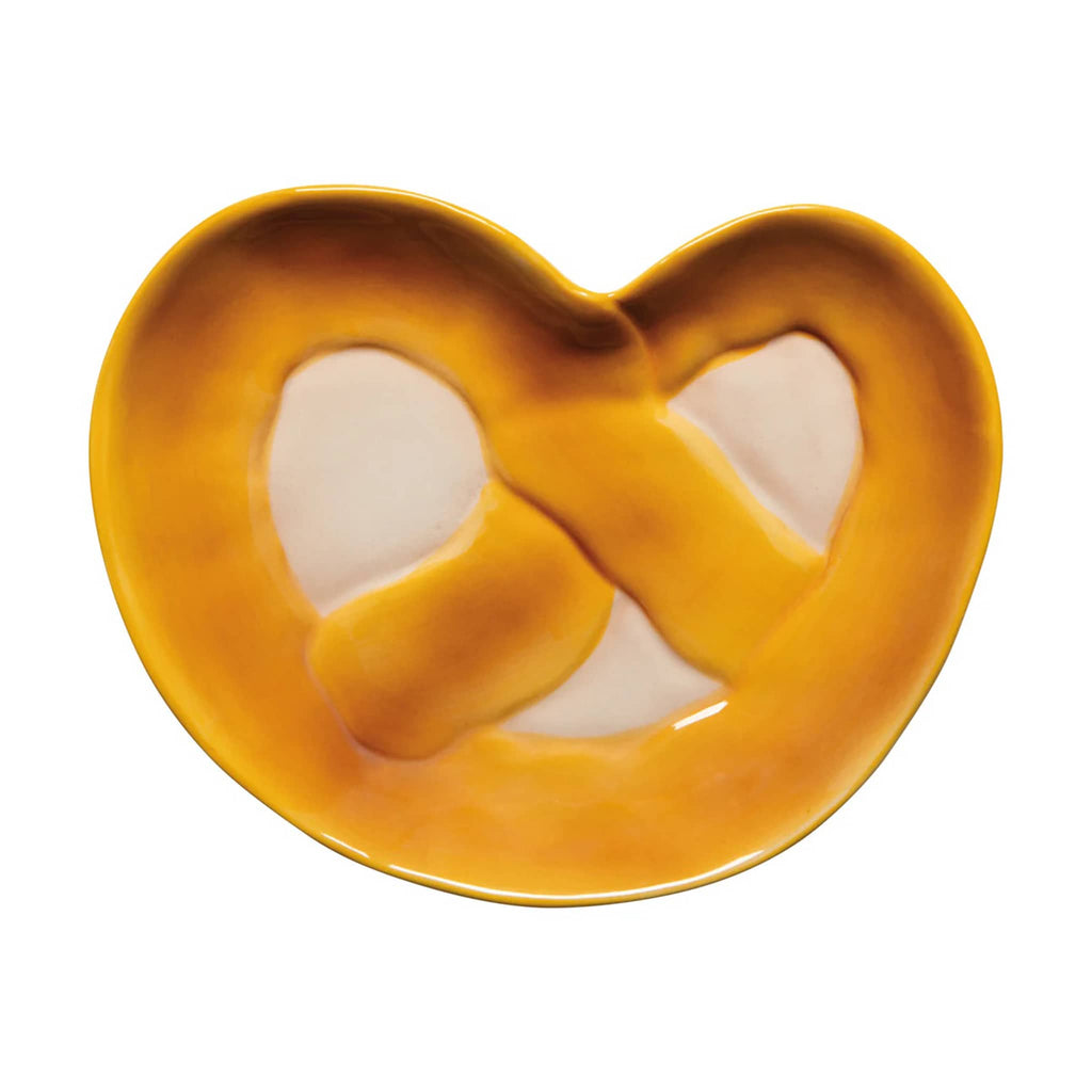 Ceramic pretzel shaped trinket or serving dish on a white background.