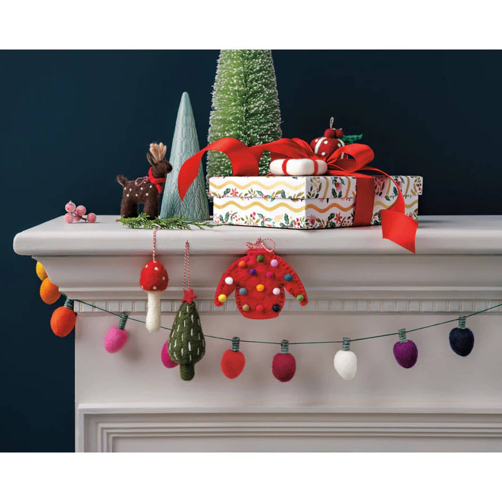Decorative Christmas mantel with presents, ornaments, and a string of felt lights.