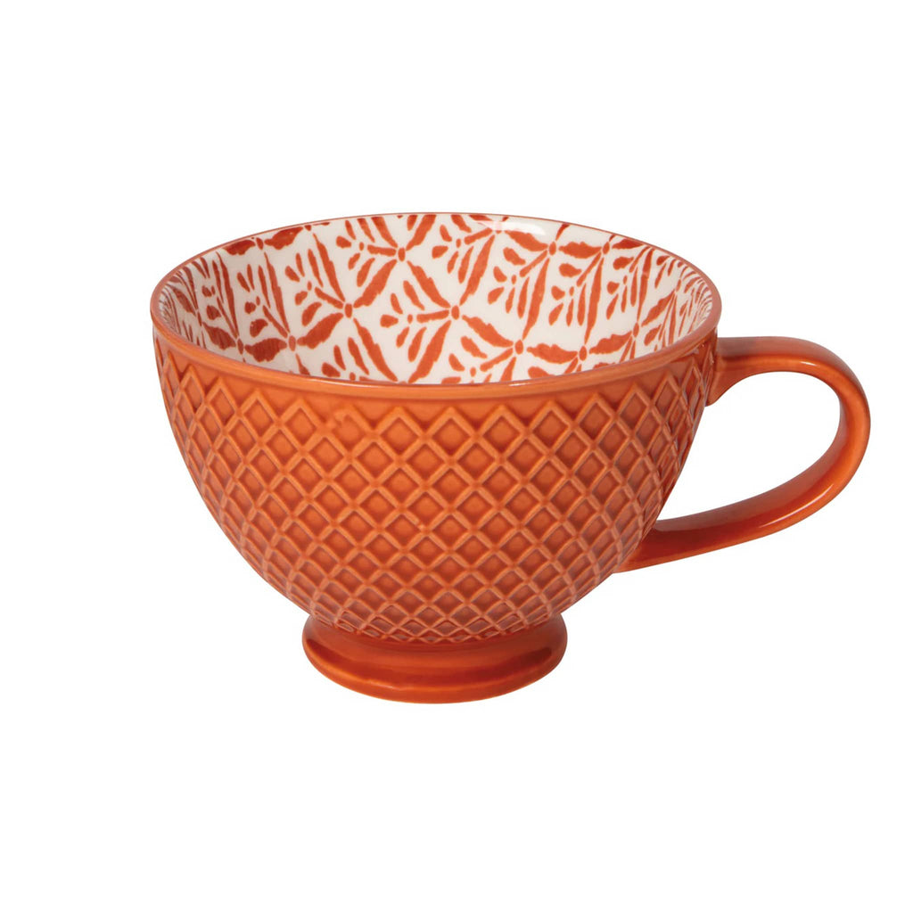Orange textured mug with a white interior pattern on a white background.
