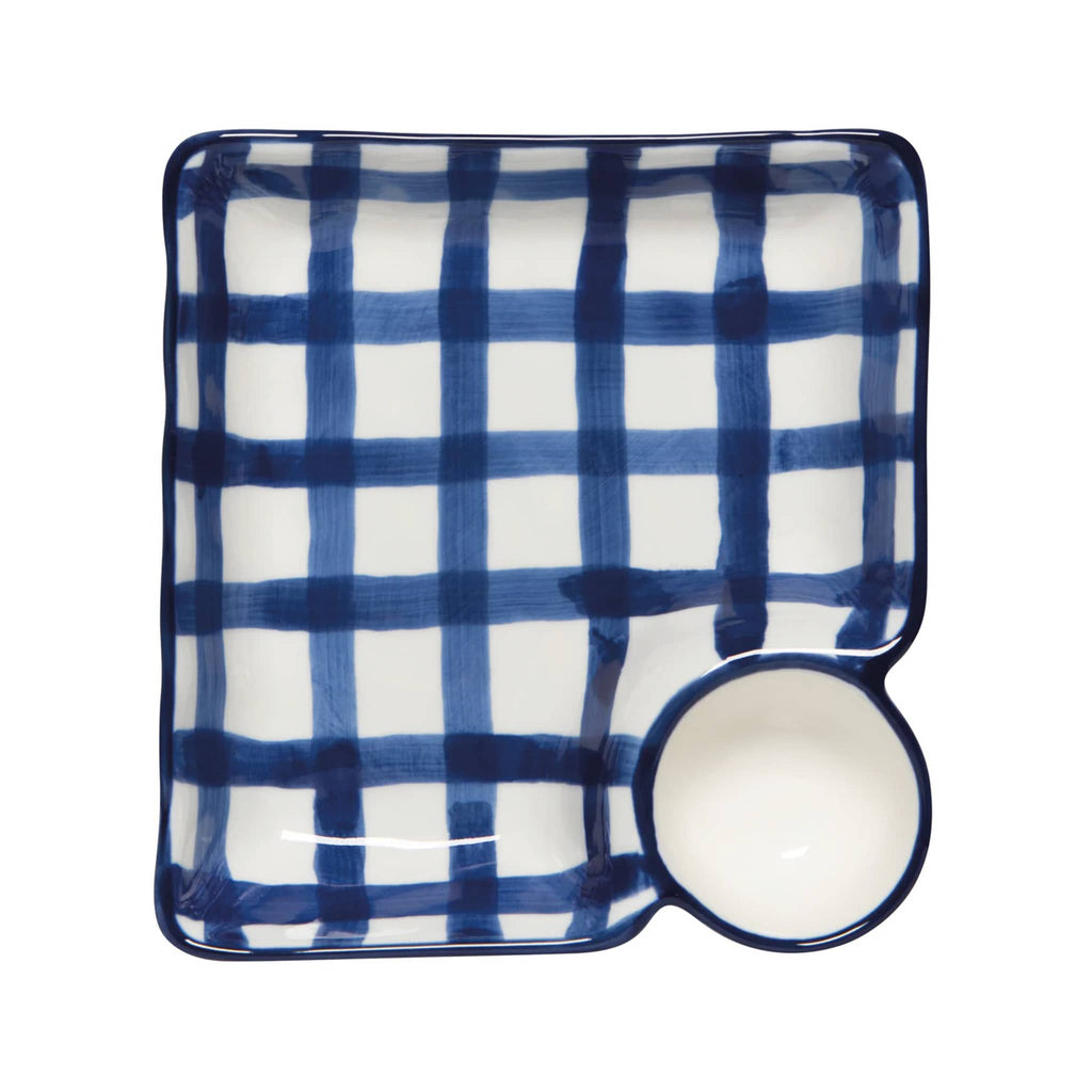 Square ceramic plate with blue and white checkered pattern and a small bowl on a white background.