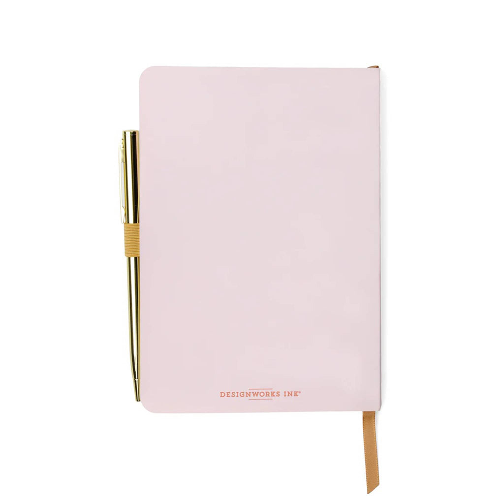 Designworks Ink pink softcover gratitude journal, back cover with gold tone pen attached.