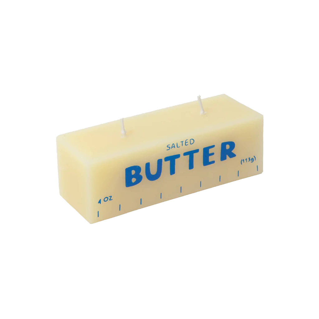 Rectangular yellow paraffin and beeswax candle that looks like a block of butter on a white background.