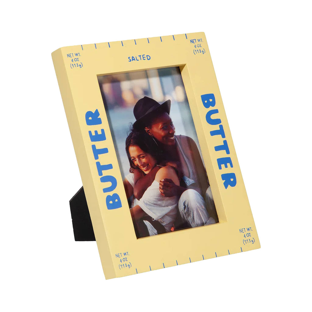 Yellow butter themed photo frame with easel holding a picture of two people.