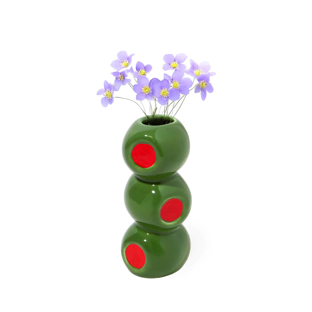 Ceramic vase that looks like 3 stacked olives with little purple flowers on a white background.