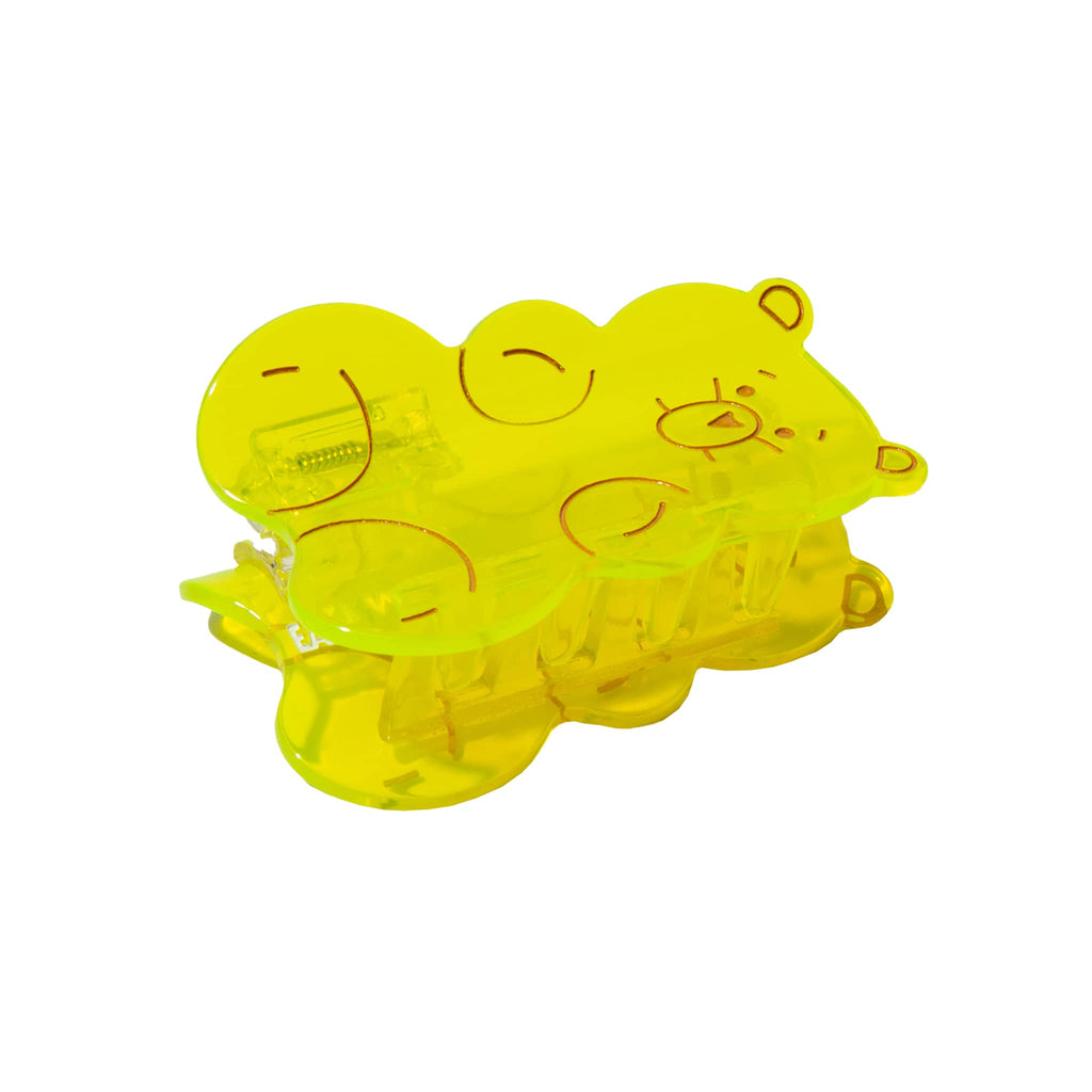 Yellow gummy bear-shaped plastic hair claw on a white background.