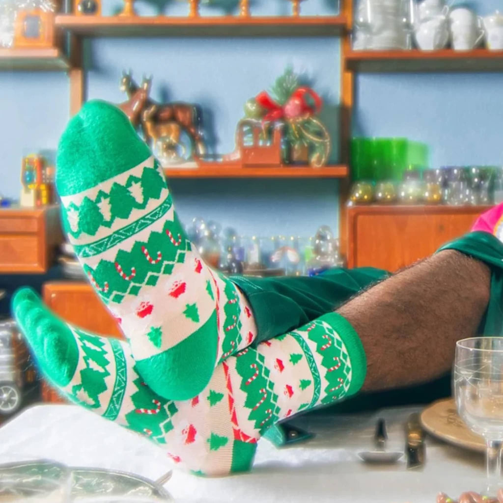 Person wearing festive socks with a kitchen background.