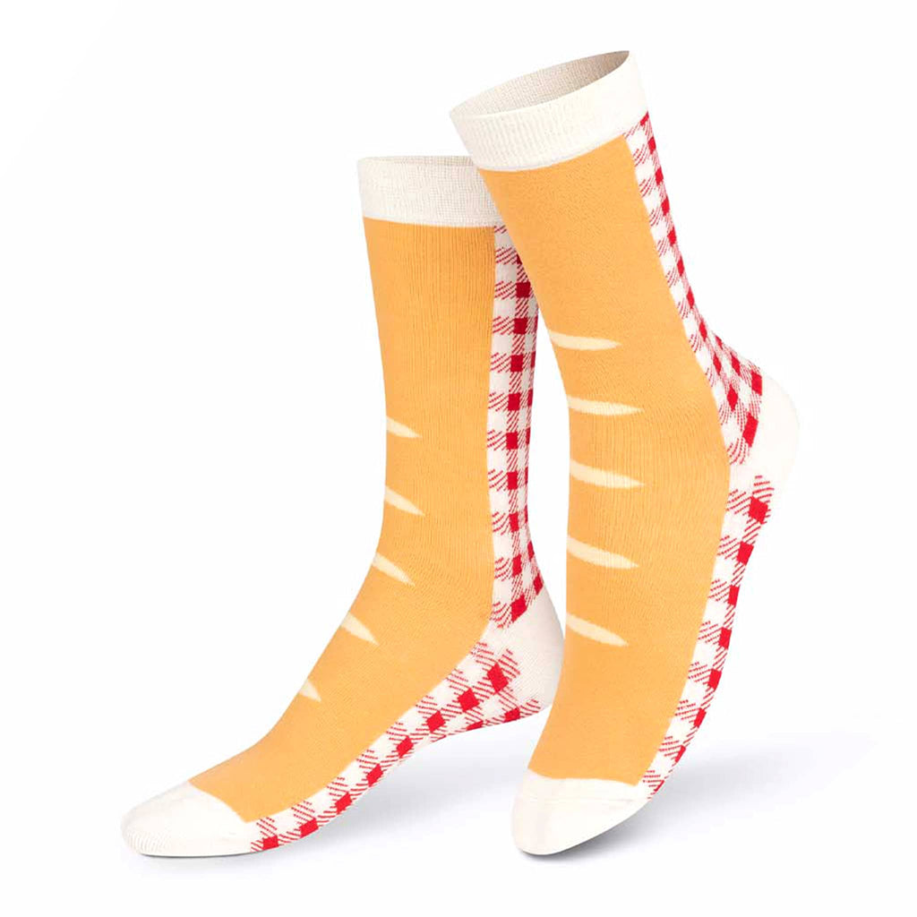 Pair of yellow socks with red and white pattern on a white background.