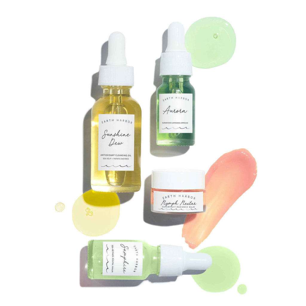 Earth Harbor Mini Smooth Sailing skincare kit to calm and renew, contents in glass bottles and jars with product blobs and smears.