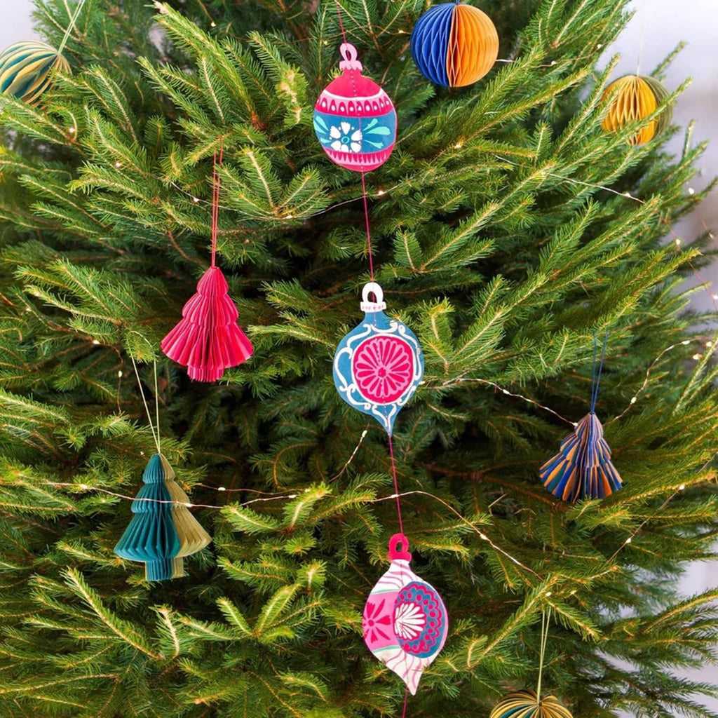 Colorful decorative paper hanging bauble ornaments garland, on a Christmas tree with other ornaments.