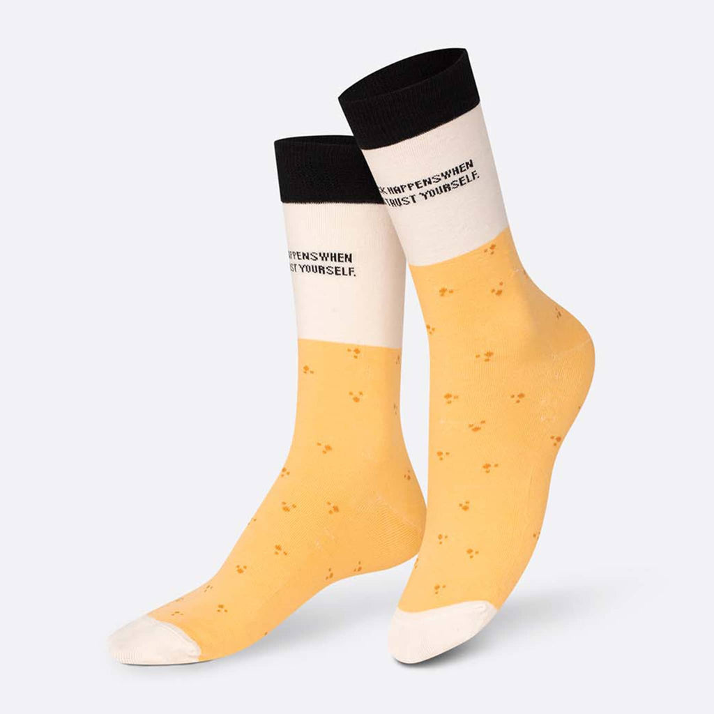 DOIY Eat My Socks fortune cookie unisex over the calf socks in yellow, white and black, on foot form.