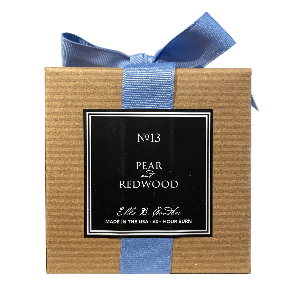 Ella B Candles "How Sweet It Is" pear and redwood scented soy wax candle in brown kraft paper box with bluebell blue grosgrain ribbon, back view.
