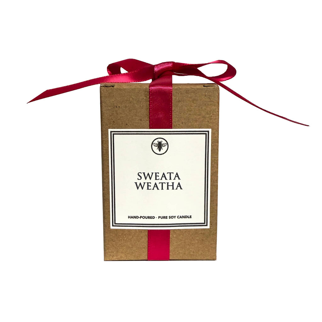 Kraft box with a dark pink ribbon and a white label with "Sweata Weatha", on a white background.