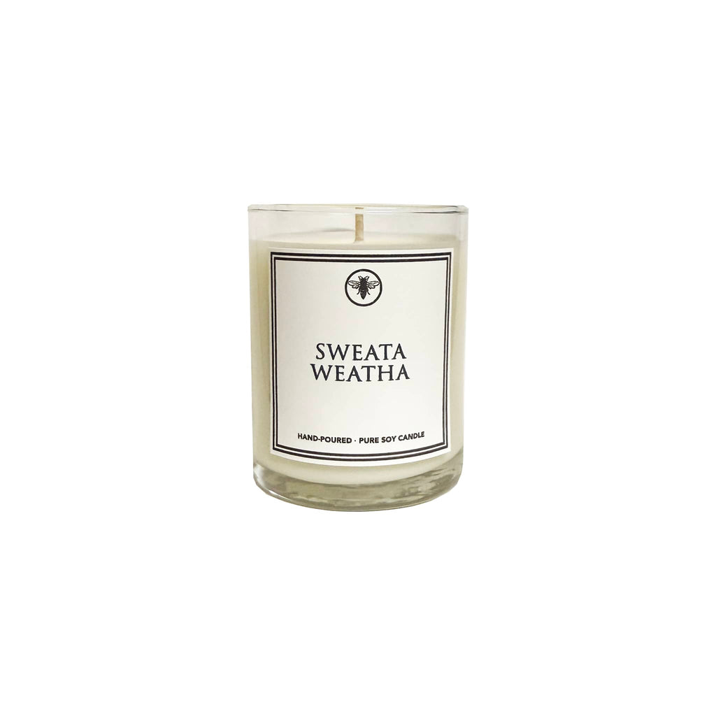 Candle with a 'Sweata Weatha' label on a white background.