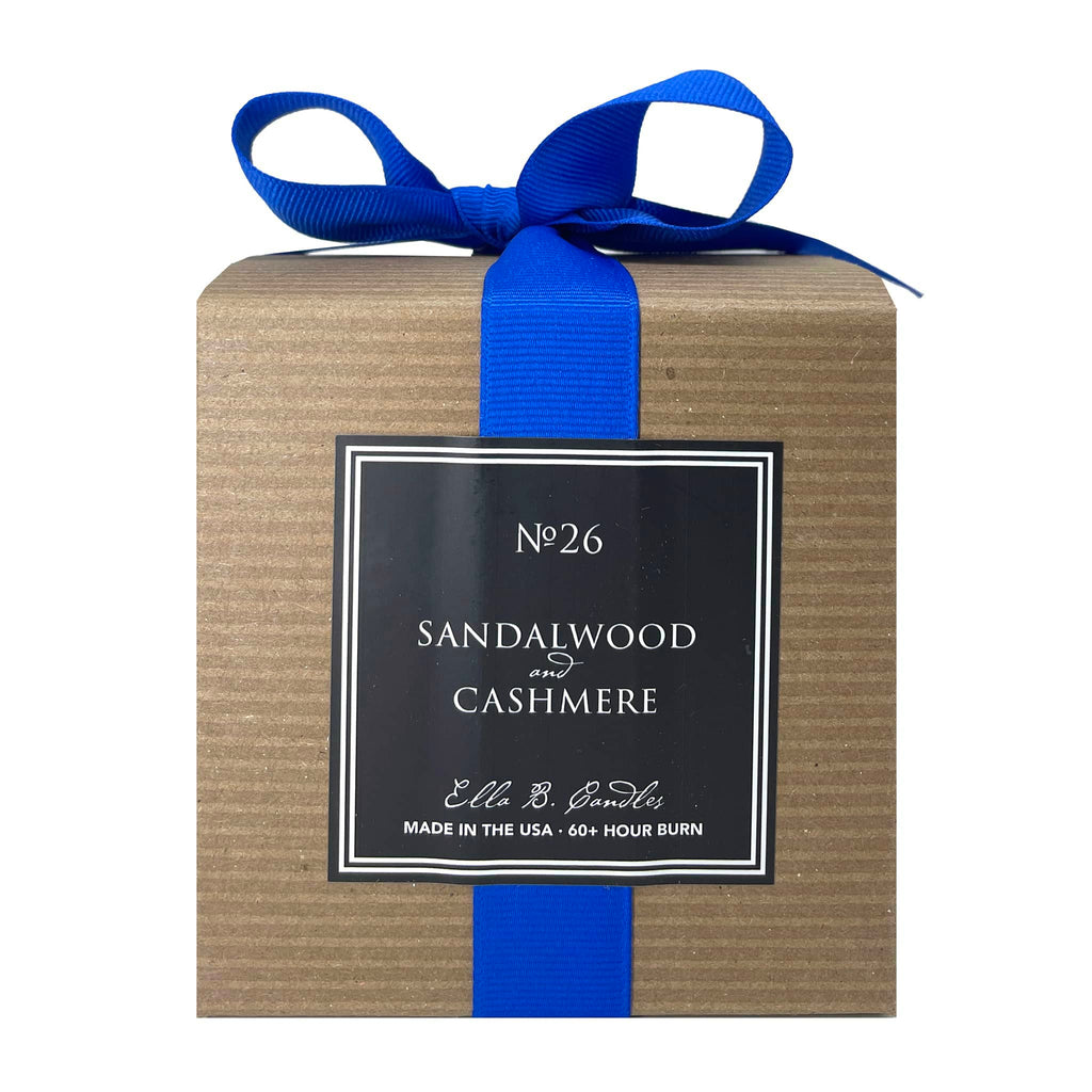 Ella B Candles Sweater Weather sandalwood and cashmere scented soy wax candle in kraft box packaging with blue grosgrain bow, back view.