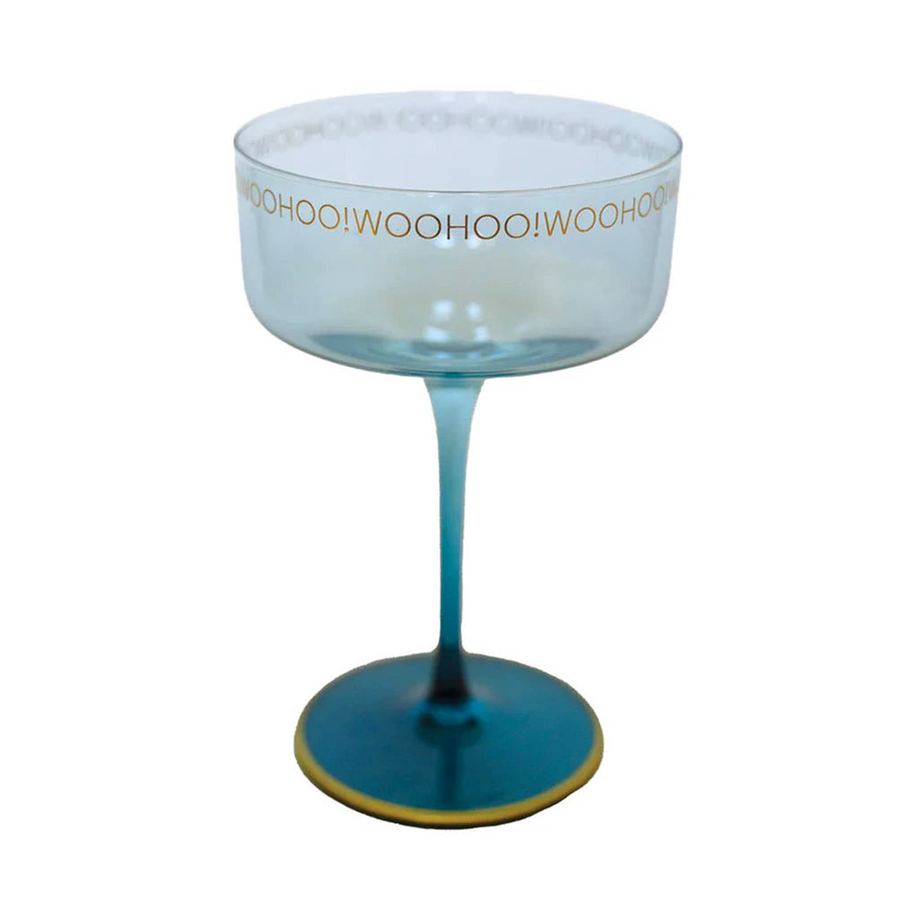 Emergency Confetti blue coupe glass with "woohoo!" in gold lettering around the top rim.