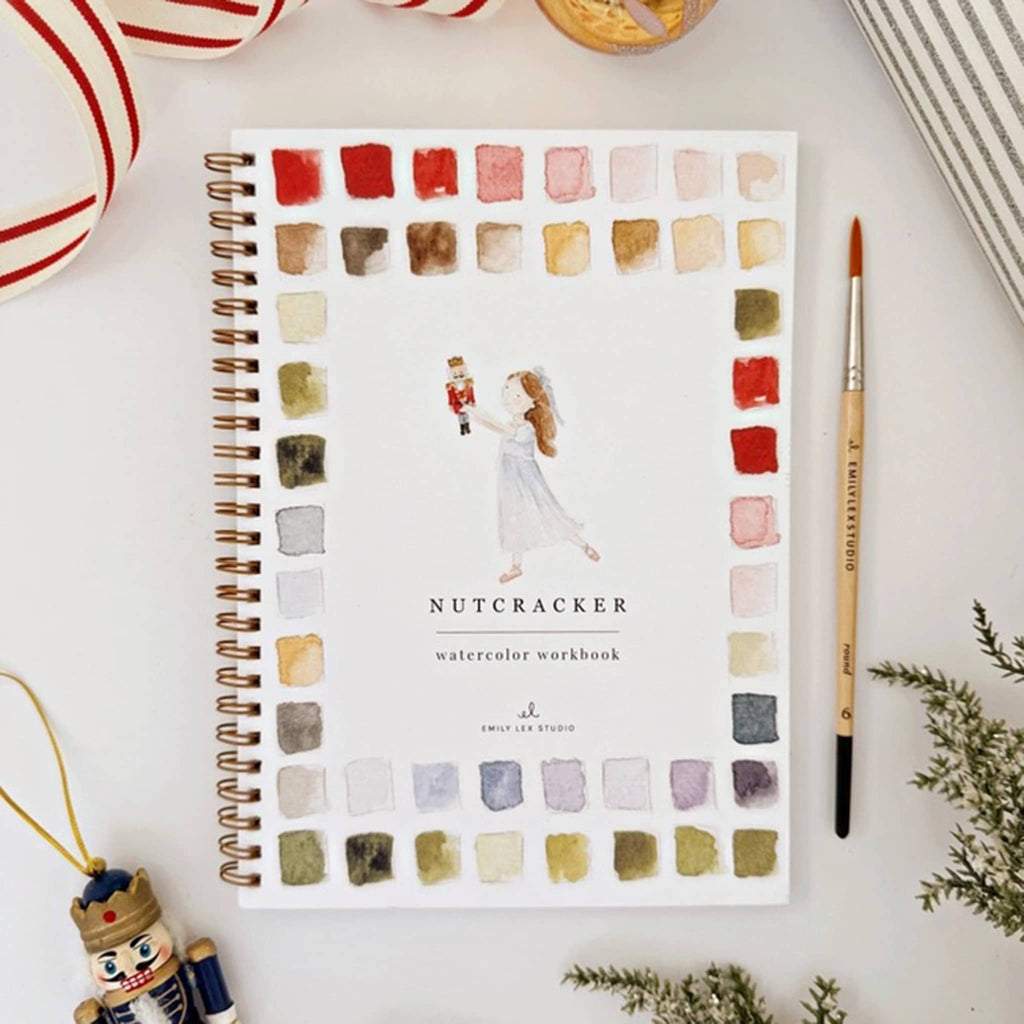 Watercolor workbook titled 'Nutcracker' with color swatches on a white surface.