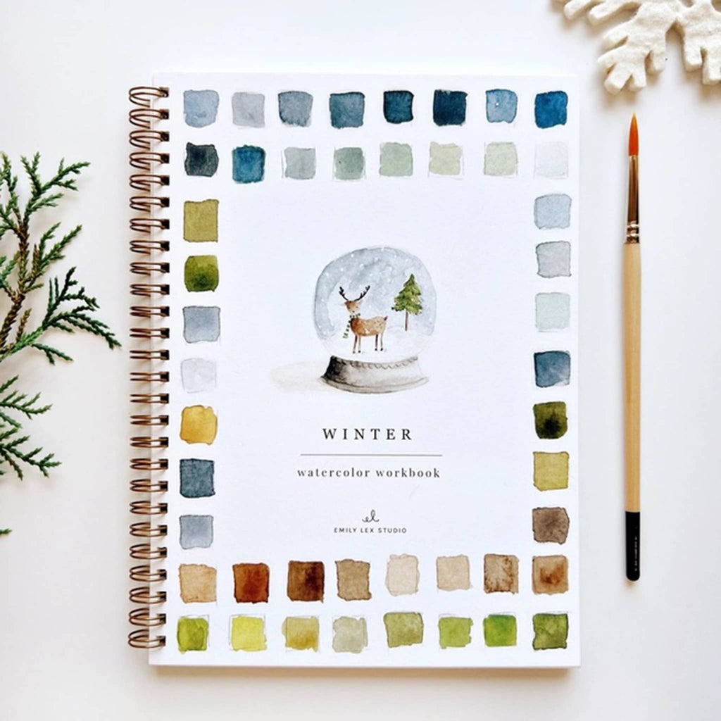 Watercolor workbook with winter theme and decorative elements on a white background.