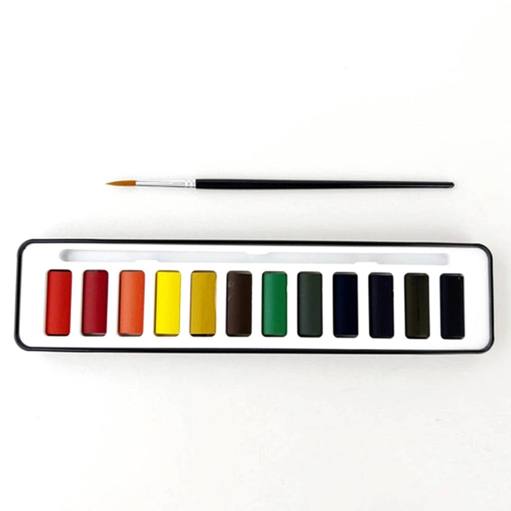 Set of watercolor paints with a brush on a white background.