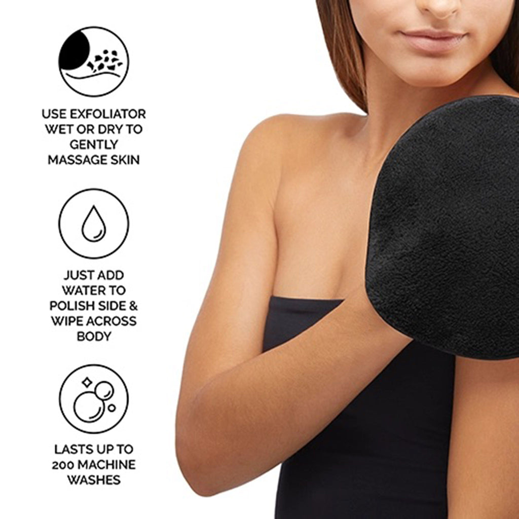 Face Halo Dual-Sided Body Exfoliating Washcloth Mitt, black side is showing with model in black towel using it on her skin.