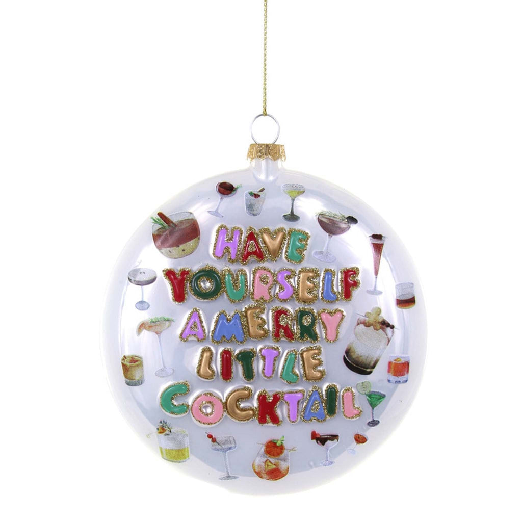 Cody Foster white round ornament with "have yourself a merry little cocktail" in colorful lettering outlined in gold glitter and little cocktail illustrations.