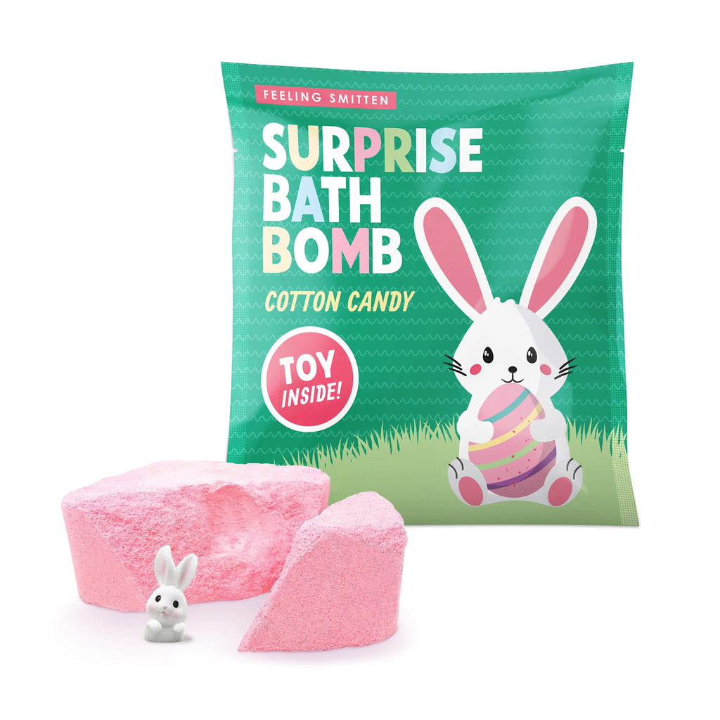 Feeling Smitten Easter Cotton Candy Scented Surprise Bath Bomb in green pouch packaging with a pink bomb in front broken to show bunny toy inside.