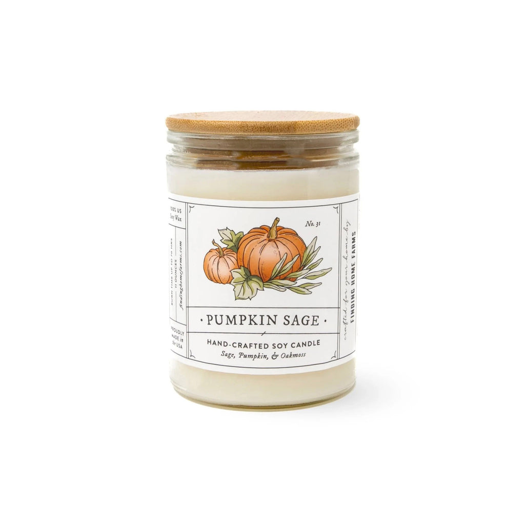 Finding Home Farms 11 ounce pumpkin sage scented soy wax candle in glass jar with bamboo lid and white label with pumpkin illustration on it inspired by vintage seed packets.