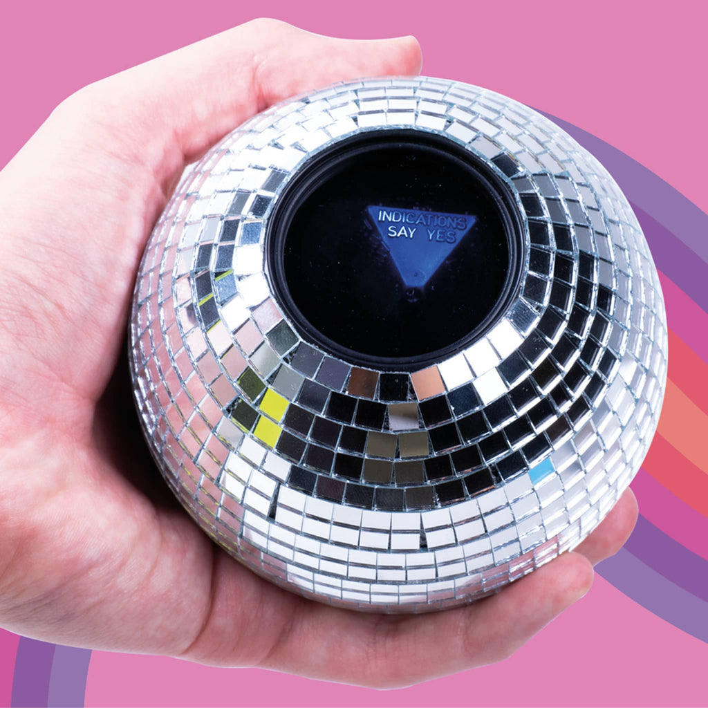 Hand holding a silver disco decision ball against a pink background.