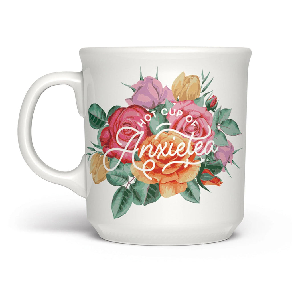 Genuine Fred white ceramic mug with "hot cup of anxietea" and colorful rose illustration, handle on the left.