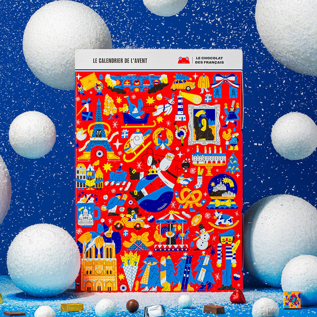 Red advent calendar with colorful designs on a blue background with white spherical objects.