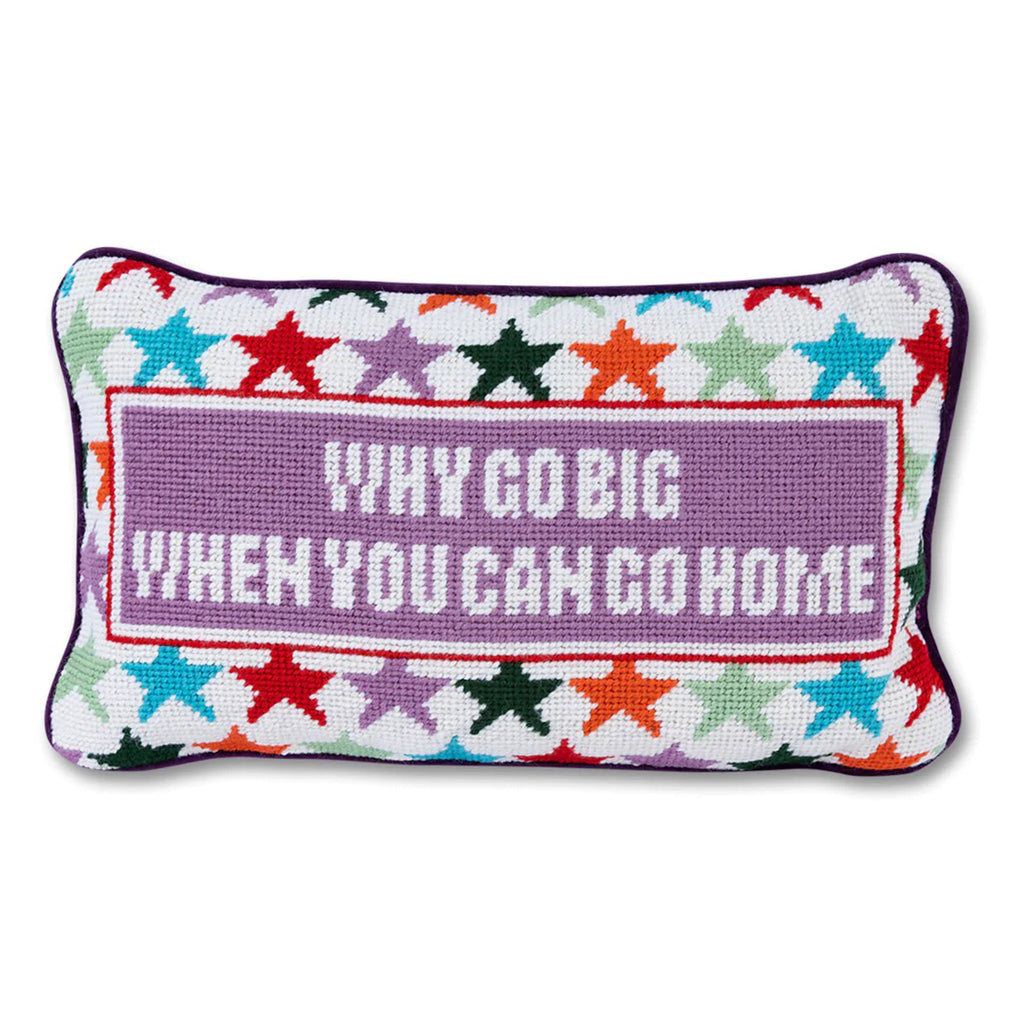 Furbish studio needlepoint pillow, white with colorful stars and "why go big when you can go home" on the front.
