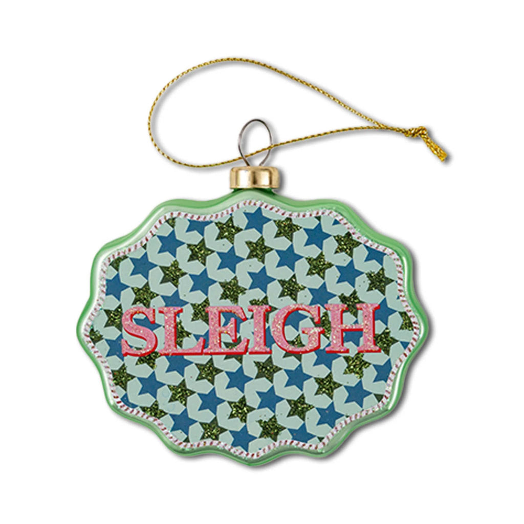 Decorative glass ornament with scalloped edge and 'Sleigh' text on a white background.