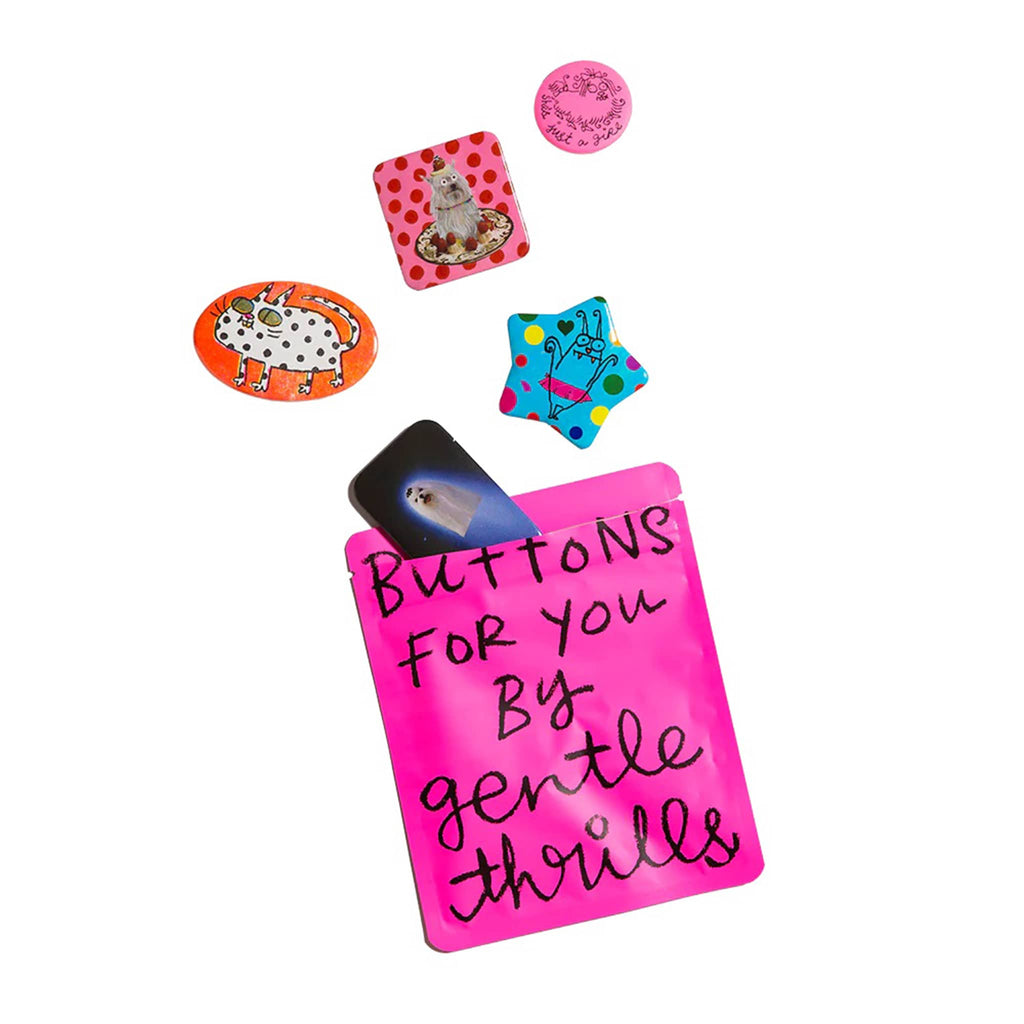 Collection of colorful pinback buttons with hot pink pouch that says 'Buttons for you by gentle thrills' in black text.