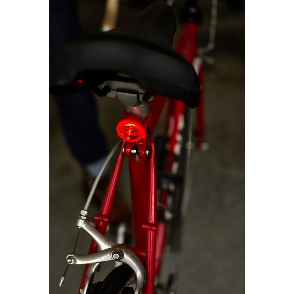 Gentlemen's Hardware Twin Bicycle Lights, red light shown on the back of a bike, lit.