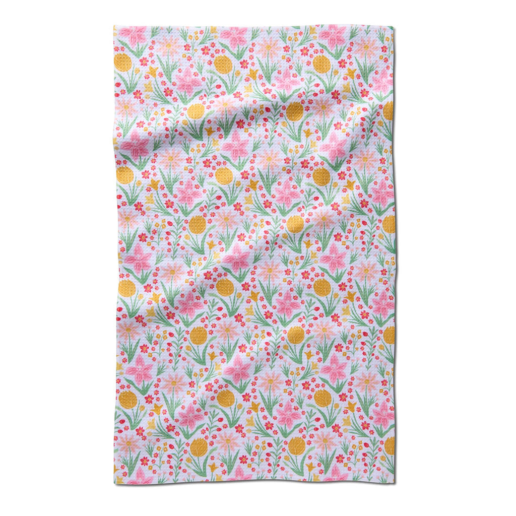 Geometry Garden of Light eco-friendly kitchen tea towel with a pink, green and yellow floral print.